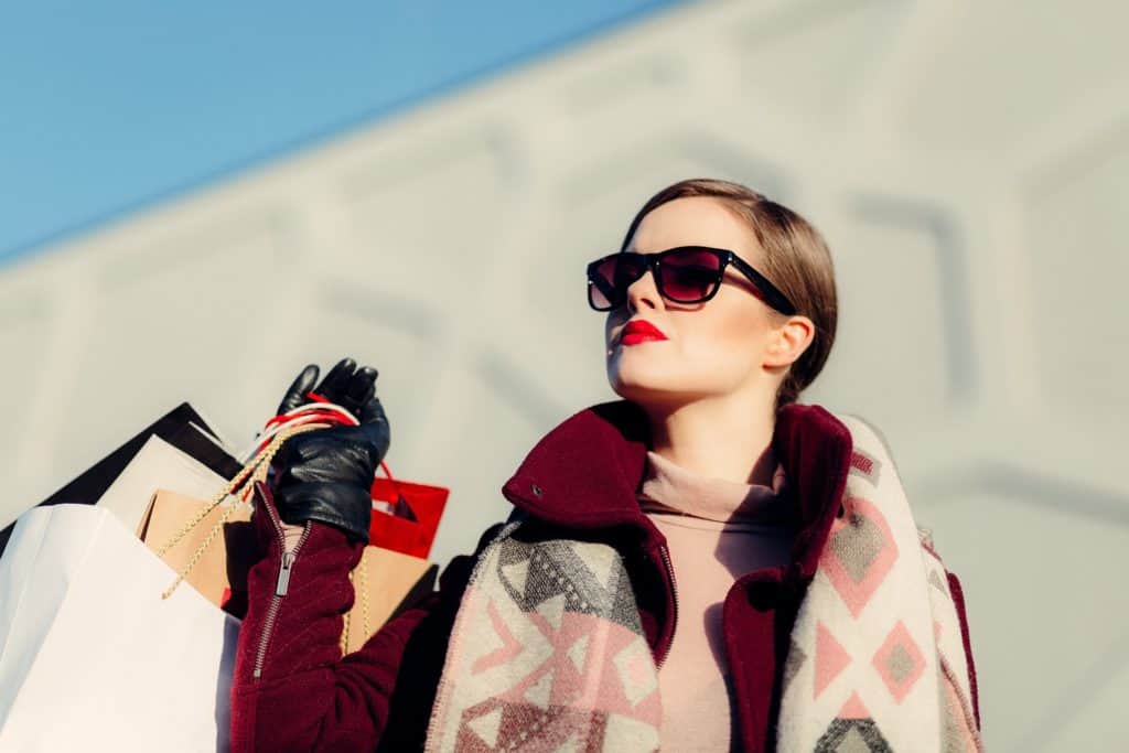 female holding an abundance of shopping bags