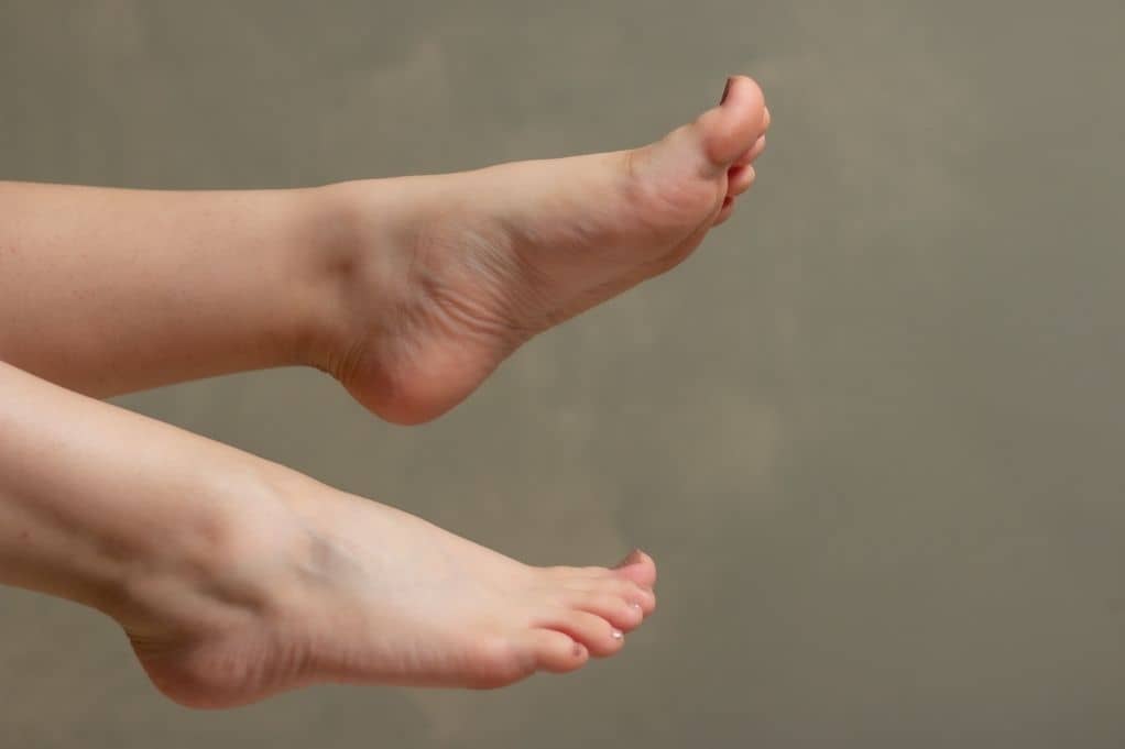 Two woman's feet in the air, one is arched