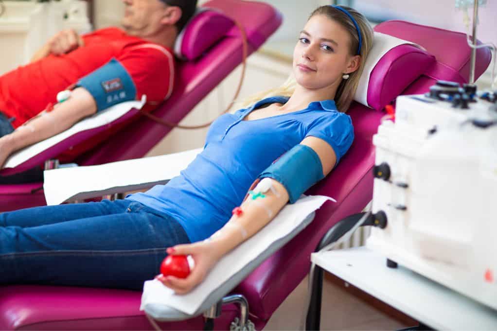 Two people donating plasma in one of the highest paying plasma donation centers