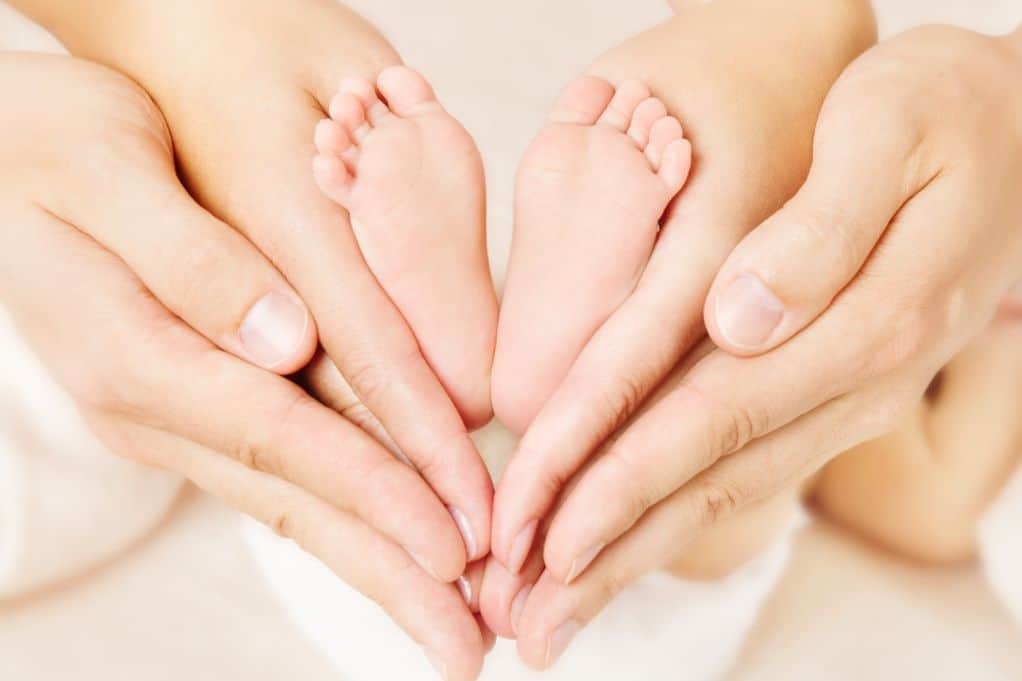 How to sell hand pics : family's hands cupping baby feet