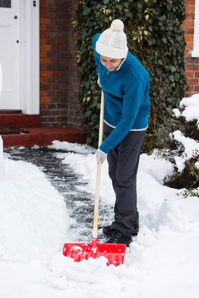 male teen shoveling snow