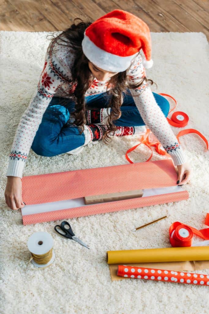 13 year old female teen wrapping gifts