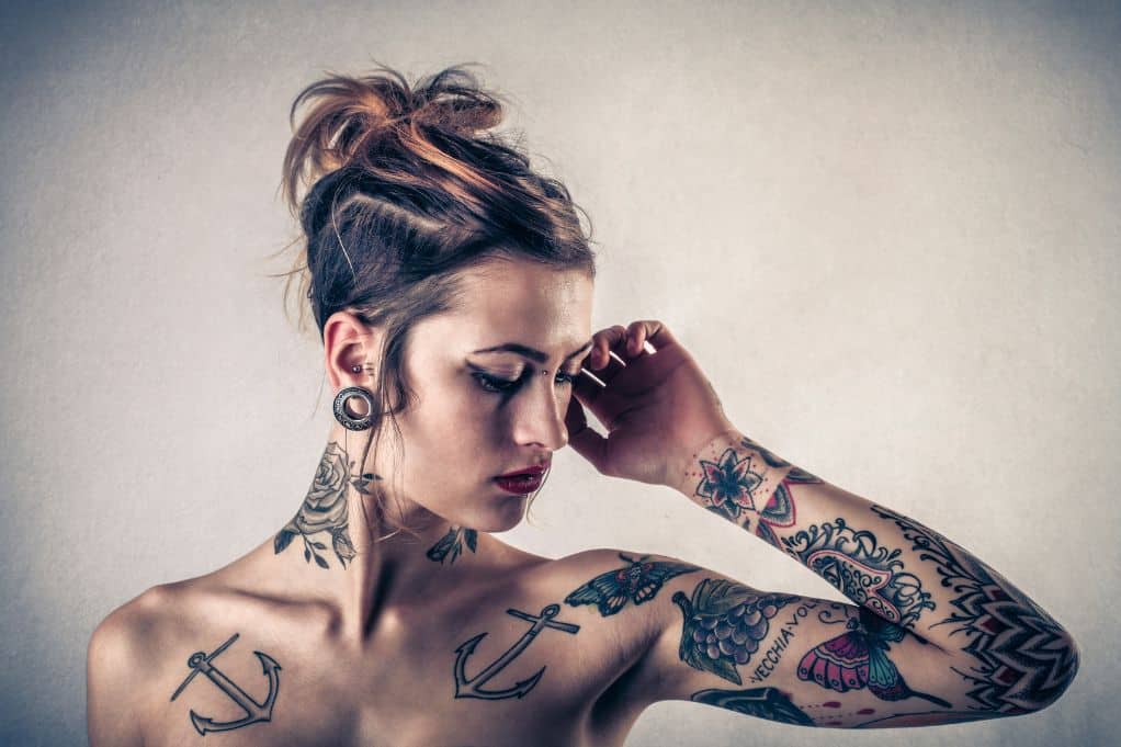 close up of female model with tattoos & piercings
