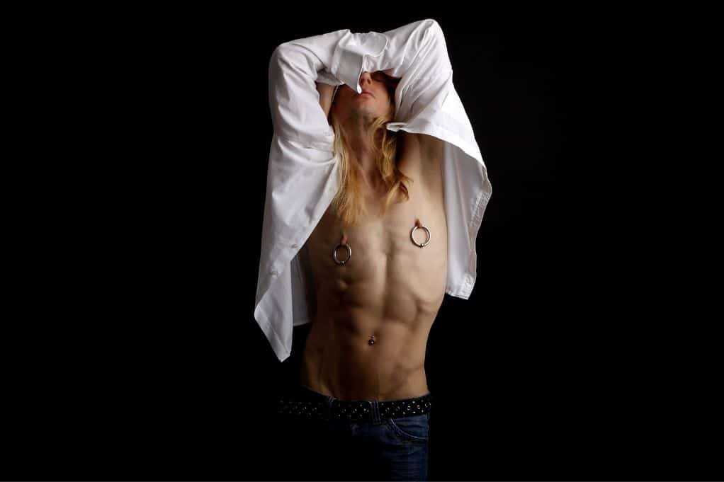 male model with large nipple hoop piercings