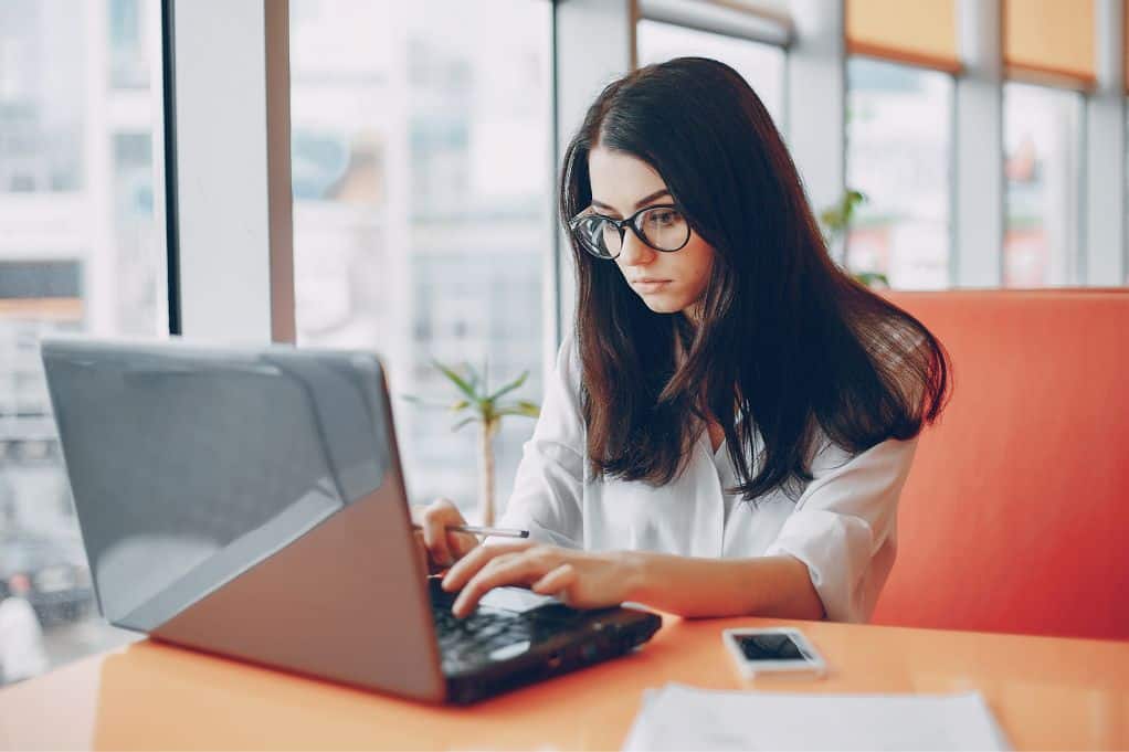 female freelance writer working on her laptop