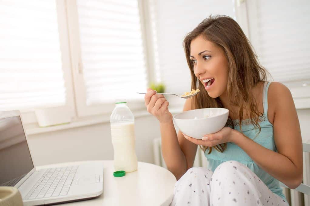 college student eating cheap cereal for breakfast