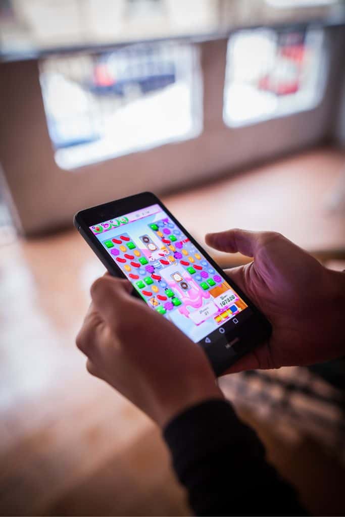 person playing games on their cellphone