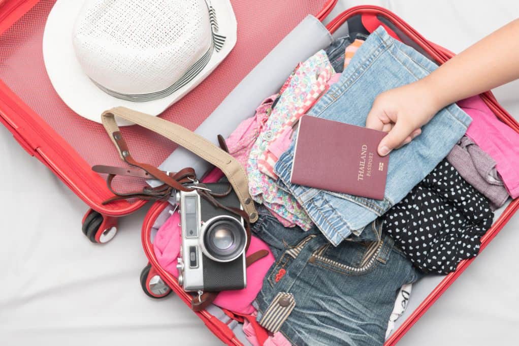 open suitcase filled with clothes and travel gear