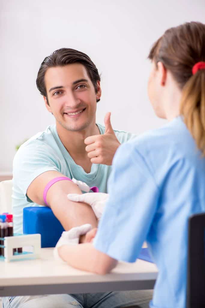 young male donating plasma