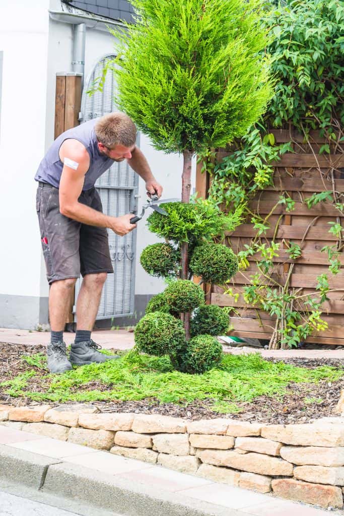 man working on his landscaping side hustle