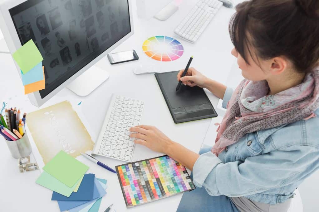 female graphic designer working at her desk