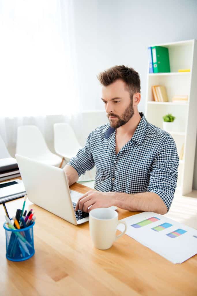 man working on freelance writing project