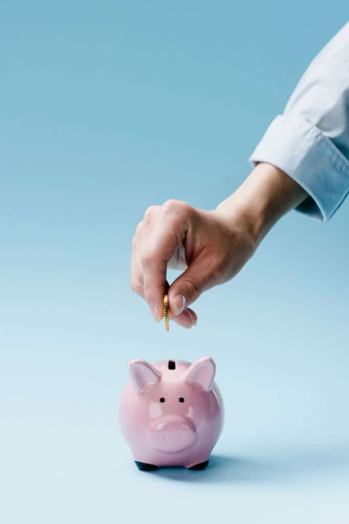 coin being placed inside piggy bank