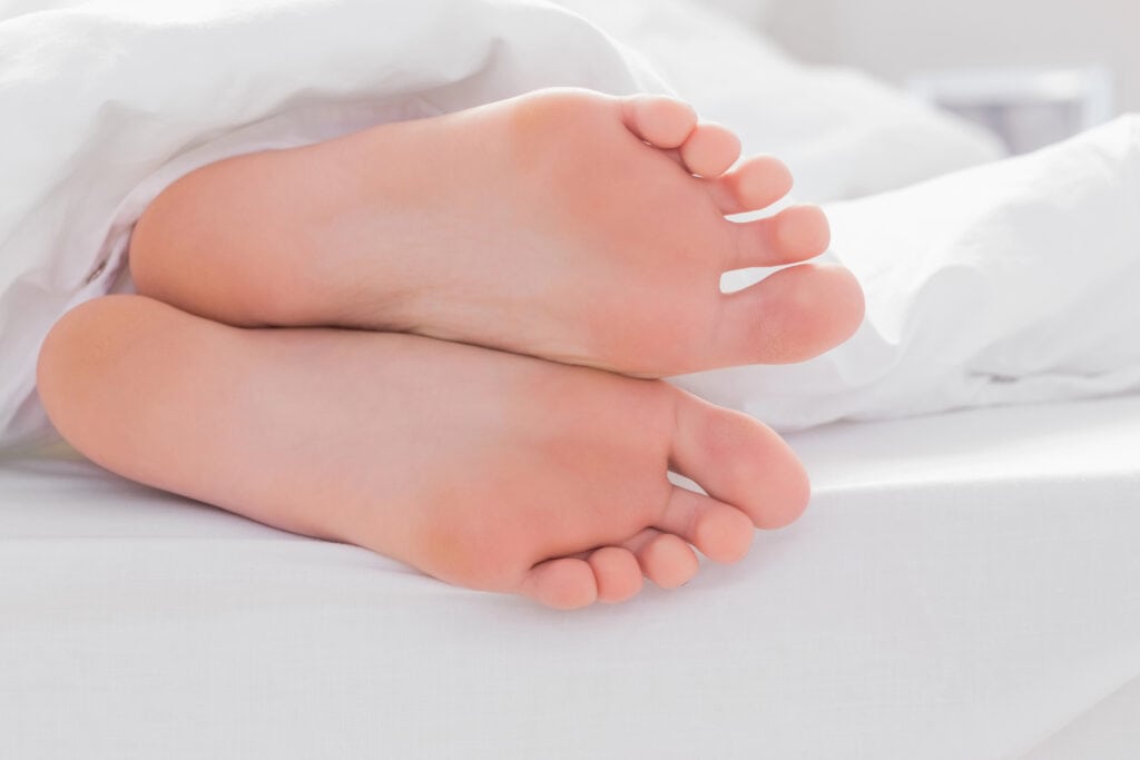 feet soles peaking through blankets