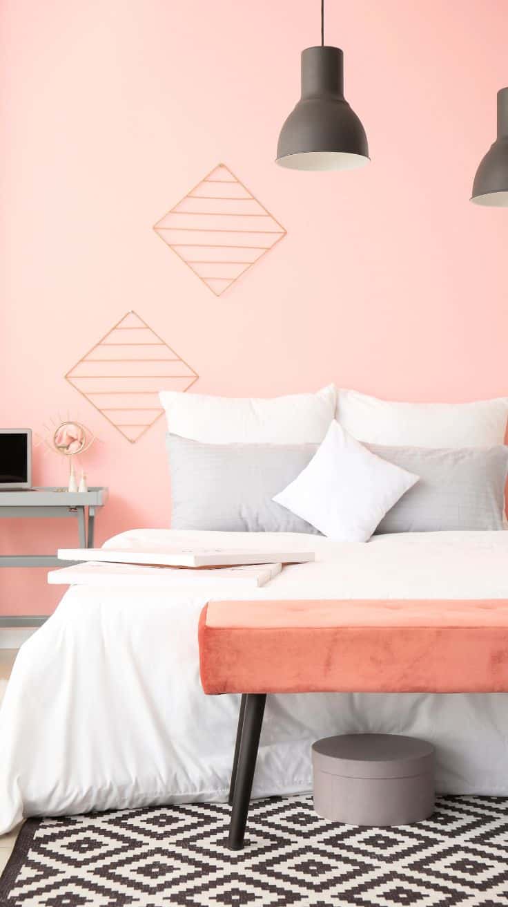 a modern pink bedroom with black and white accents