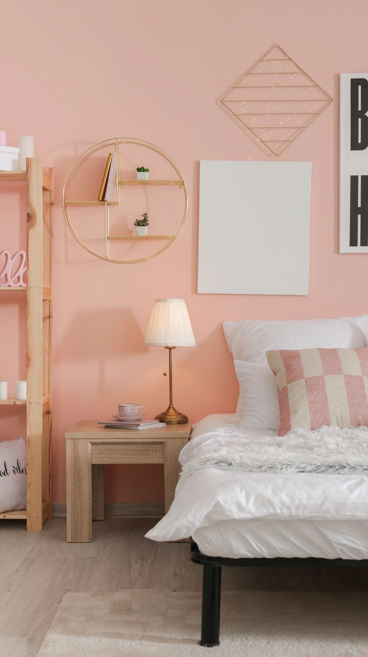 a modern bedroom with pink walls and decor pieces